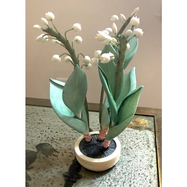 Carved polychrome lily of the valley. Potted in a small oblong shaped pot with little risers.