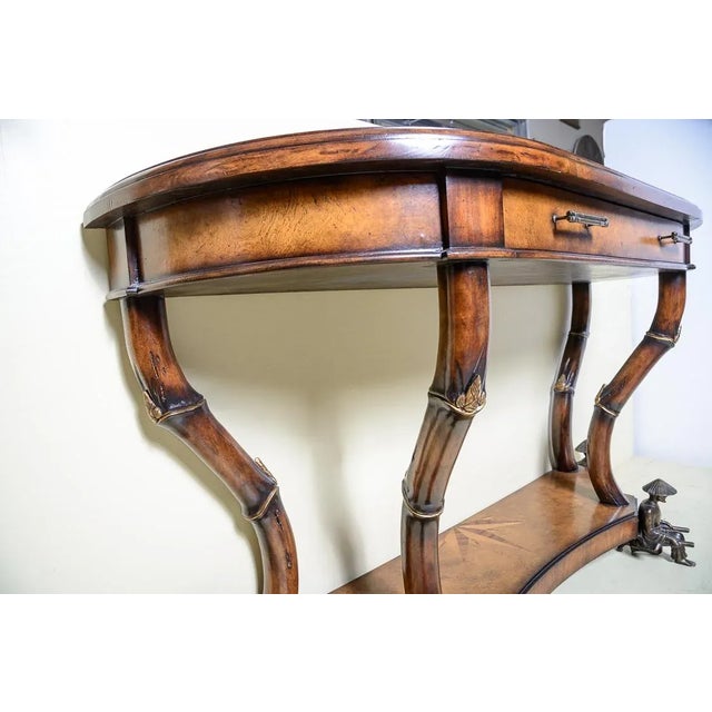 Wide wood console table.with Inlay accent top and , one drawer.. Faux bamboo metal hardware and legs. Rickshaw men at...