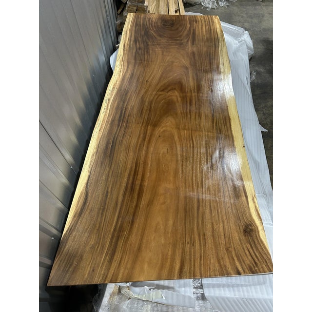 One tree. One top. One of one. A true single-slab live edge table: one continuous cross-section of a single Saman tree...