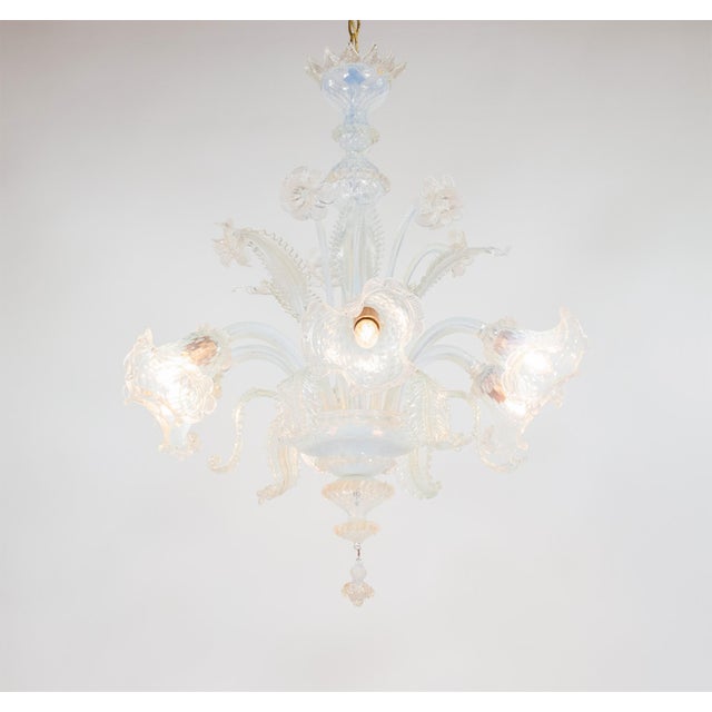 This exquisitely handcrafted gold-infused opaline Murano chandelier features six arms extending from the central bowl. The...