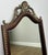A striking vintage French mirror featuring an elegant oak frame with ornate brass decorative crest detailing to the top....