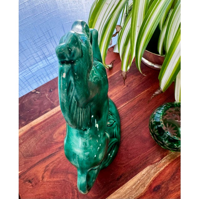 This vintage ceramic horse sculpture features a rich emerald green glaze and a dynamic rearing pose, giving it strong...