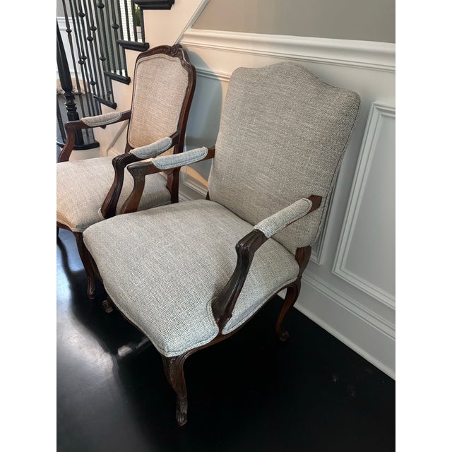 Offered is a pair of coordinating armchairs with a blue/gray upholstery. This set is unmarked as the upholstery is not...