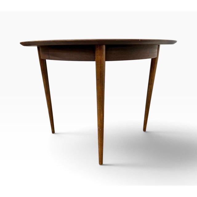 A striking example of American Mid-Century Modern design, this American of Martinsville “Accord” Round Walnut Dining Table...