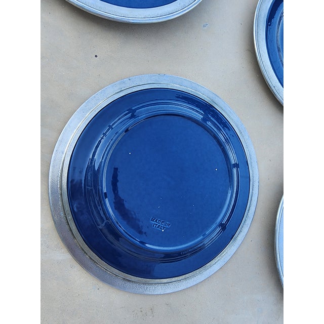 Great set of 11 plates in blue by Match. All with pewter rims and hallmarks.