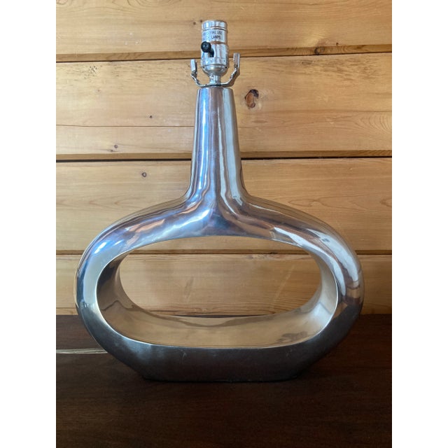 This is a handsome pair of polished metal table lamps. They are silver in color. They're heavy and a substantial size....