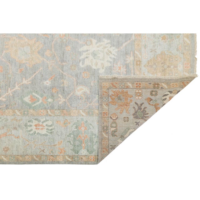 Elevate your living space with this exquisite hand-knotted wool rug, inspired by traditional Oushak artistry. Featuring a...