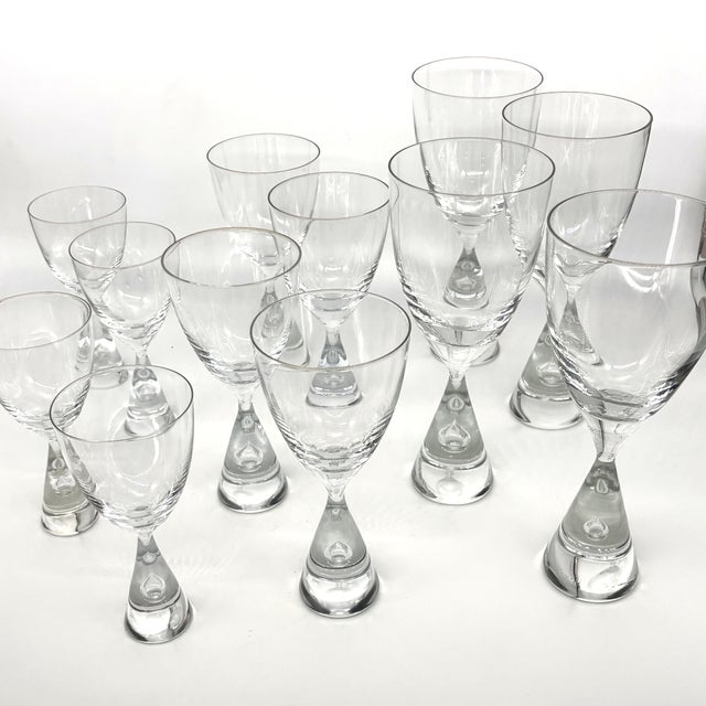 Elegant set of 12 Holmegaard Princess crystal glasses designed by Bent Severin for Holmegaard, Denmark. This complete...