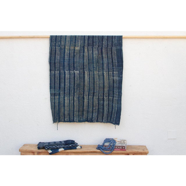 A masterwork of Malian textile heritage featuring deep indigo saturation and symbolic geometric motifs. Originating from...