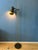 Mid century brass floor lamp with one adjustable spot. The lamp is made out of metal and has a brass/messing look. The...