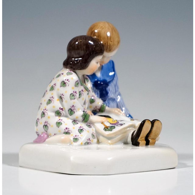 Very rare meissen art nouveau porcelain group: a boy sitting on the floor with his legs stretched out, wearing a blue-...