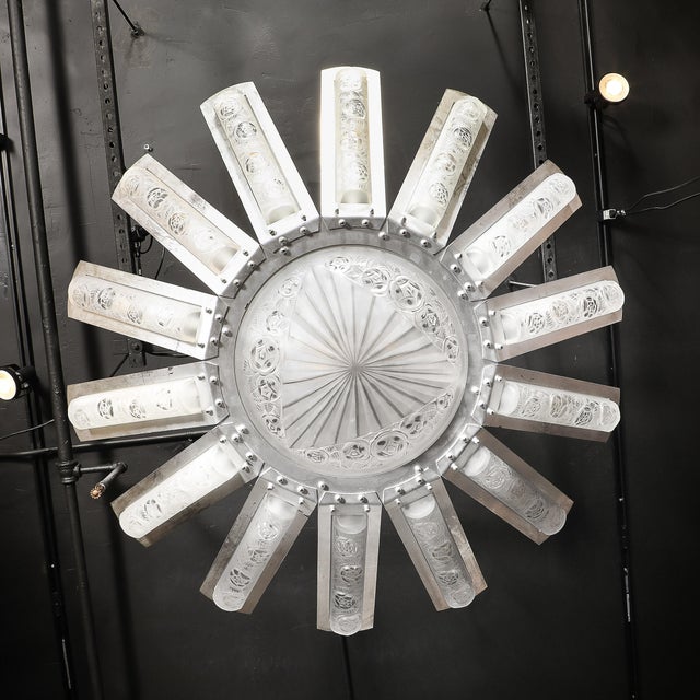 The Art Deco geometric frosted glass starburst pendant chandelier, in nickeled bronze and signed Degué, France, circa...