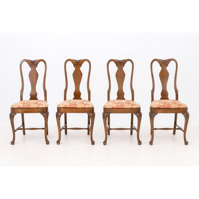 Set of Eight Queen Anne Style Walnut Dining Chairs, with red and golden floral pattern upholstered seats, vasiform splats,...