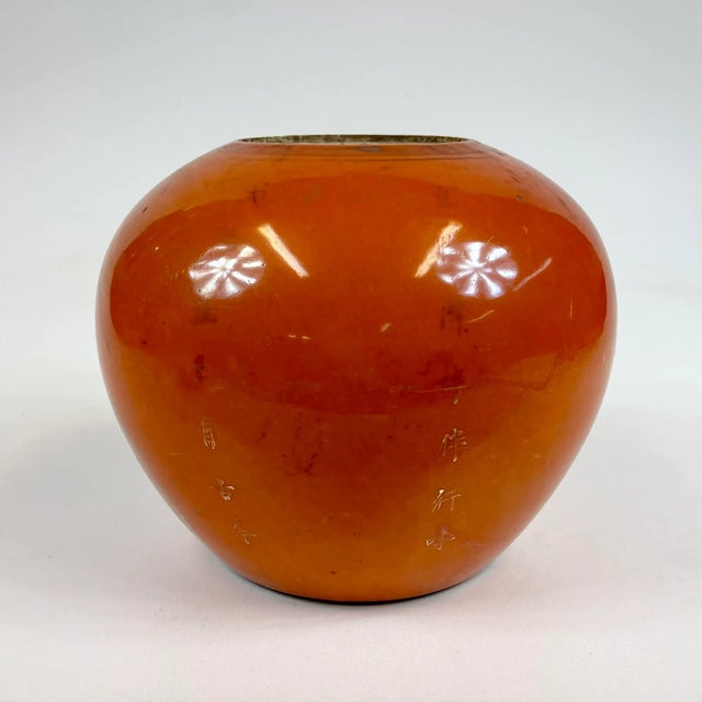 A beautiful 19th century porcelain orange vase with gold Gilt illustration of plants. In the other side has writings that...