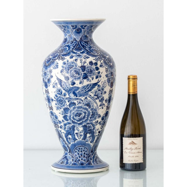 This tall Delft Blue vase by Velsen is a striking example of traditional Dutch ceramic artistry, executed in the 1950s...