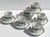 1950s Set of six white porcelain demitasse cups and matching saucers, each decorated with a blue-gold geometric pattern...