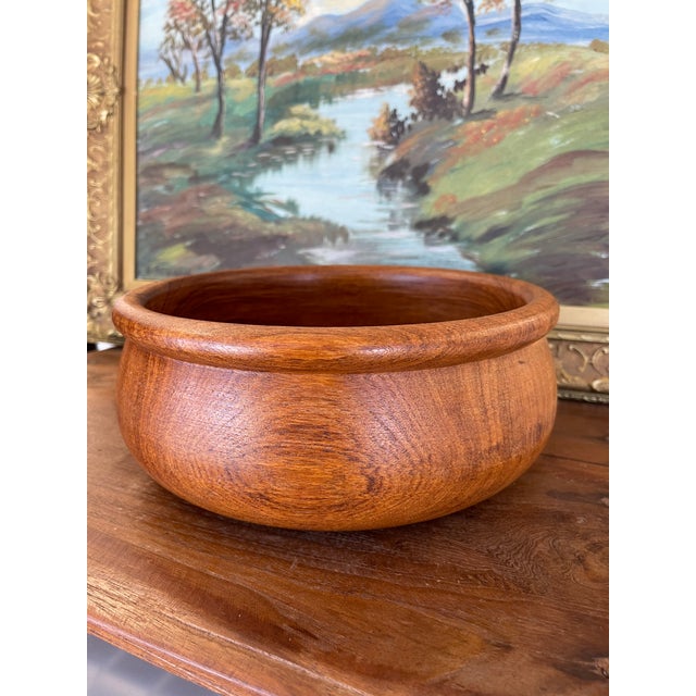 This vintage teak wood bowl was hand-turned in Thailand by Winesome, a known maker of quality teakware. Crafted from...