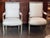 Painted Directoire armchairs with square upholstered backs and seats newly done in a plain white fabric. The top rail is...
