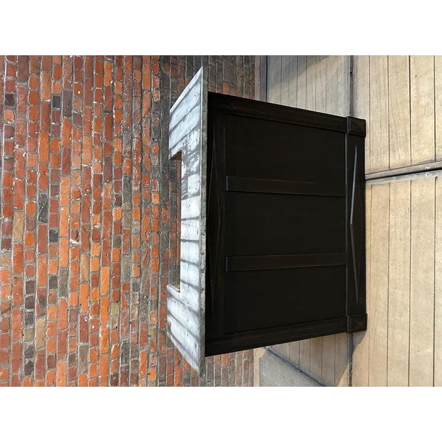 This old bar counter has been completely restored. It consists of a black patinated cabinet and a zinc top. At the back,...