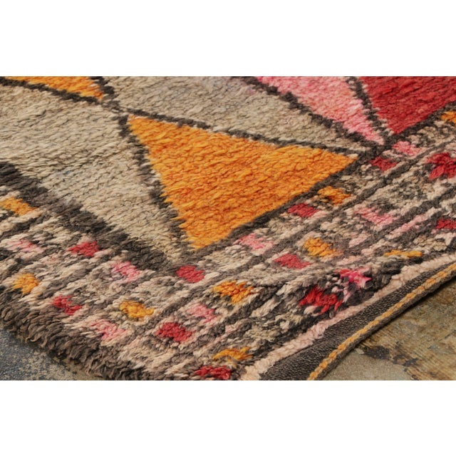 Hand-knotted in wool and originating circa 1950-1959, this 7x12 vintage Moroccan berber rug joins Rug & Kilim’s Moroccan...