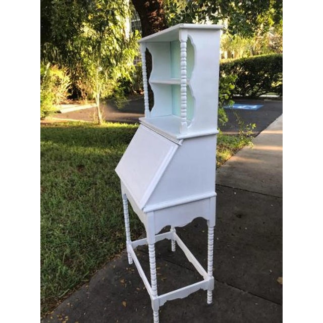 This is a super cute and unique shabby spindle secretary desk with a top shelf. It has great lines. This will need some...