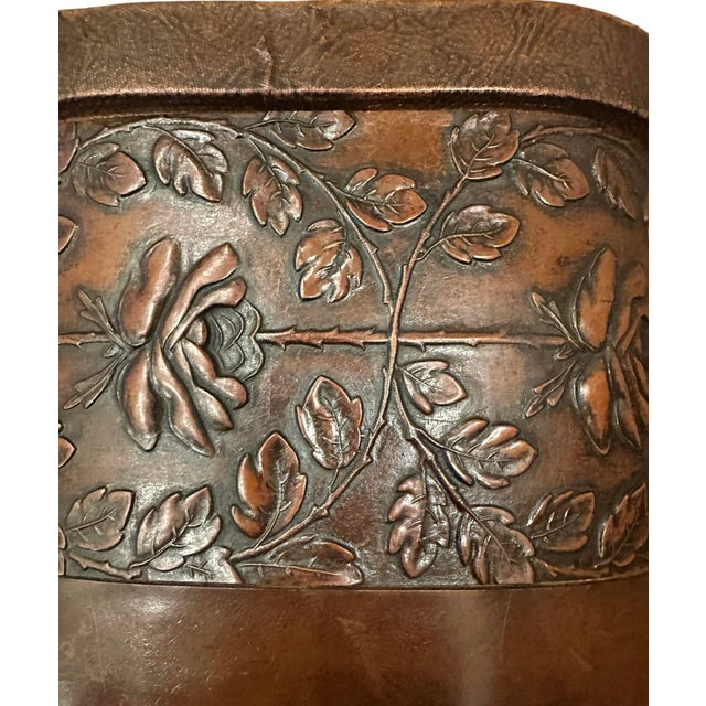 A lovely, antique leather umbrella/cane stand. Features an Arts & Crafts style embossed leather design with stylized leafy...
