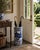 A classic blue and white porcelain umbrella stand in the chinoiserie tradition, featuring finely rendered birds among...