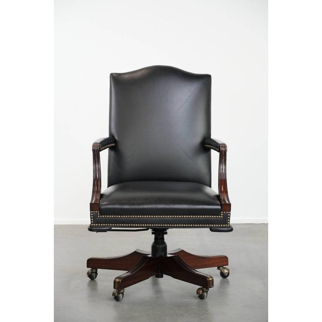 We are offering this black cowhide leather and wooden Chesterfield office chair in English style on casters. This timeless...
