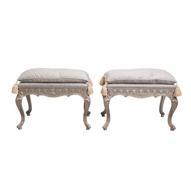 Vintage hand-carved French Louis XV Rococo style vanity benches. They feature gilded finishes, striped fabric upholstery,...