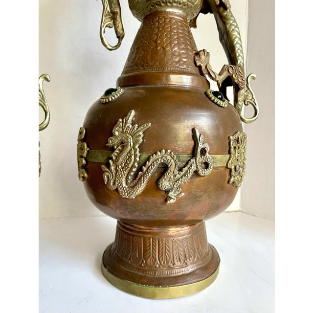 Here is an amazing pair of Tibetan vases that feature two figurative dragons climbing the sides and dragon motifs around...