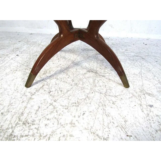 This small midcentury wood and glass side table is perfect for that small accent room or home office. The base features a...