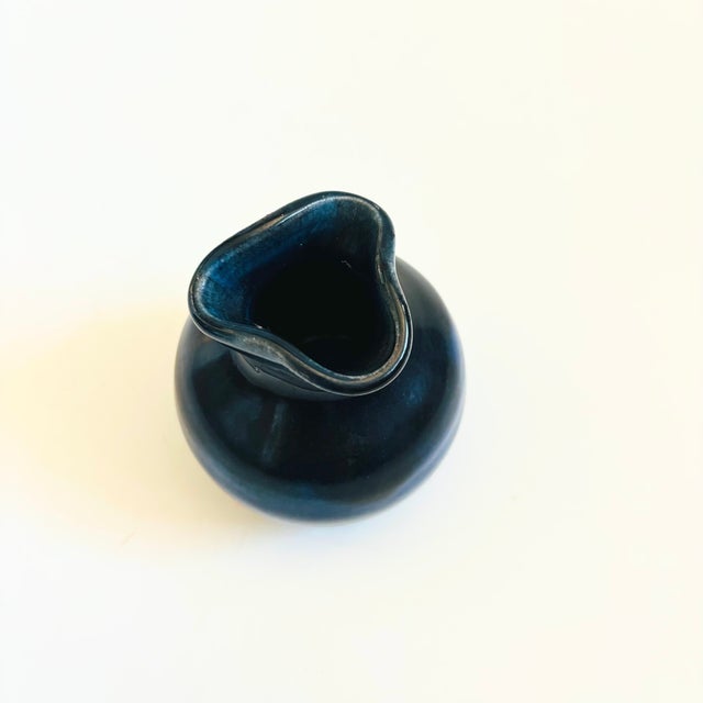 A vintage studio pottery bud vase. Lovely blue glaze that fades from darker at the top to lighter at the base. Signed on...