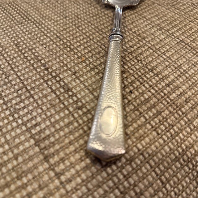 Sterling silver hammered finish antique serving spoon. No monogram.