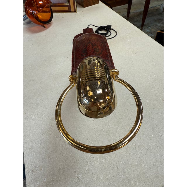 Elegant and rare table lamp by Traso Milano, Italy, 1970s, wrapped entirely in deep burgundy snakeskin. The lamp’s long,...