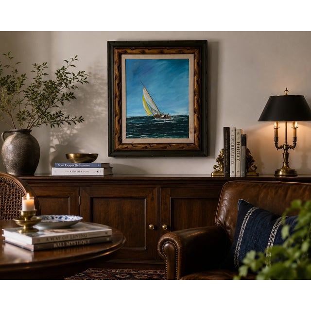 Charming vintage maritime oil painting depicting a sailboat navigating through ocean waves beneath a vibrant blue sky. The...