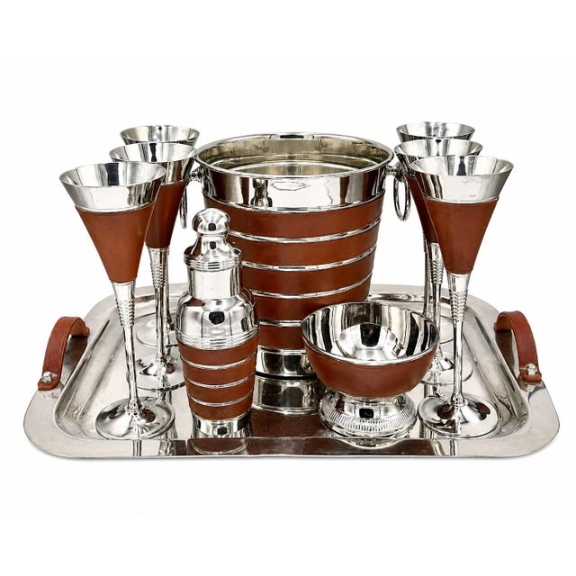Details: -Vintage stainless steel barware set with brown leather accents -Crafted in stainless steel and accented with...