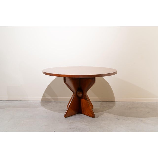 Mid-century Italian coffee table from the 1950s, crafted from walnut. It features a round table with a wide, smooth top...
