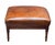 A fine French ottoman or stool, featuring a handsome upholstered seat of hand-dyed brown leather, with nail-head trim...