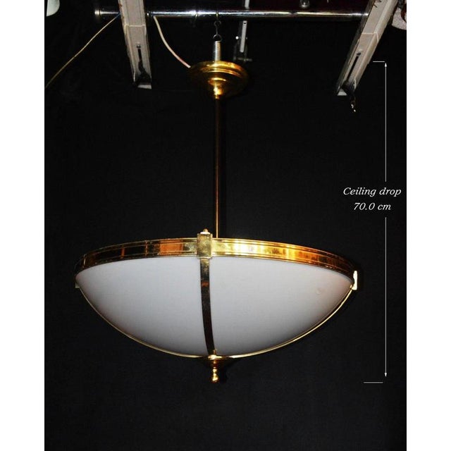An impressive large-scale mid-century ceiling light dating to circa 1960, combining a brilliant white opaline bowl with...