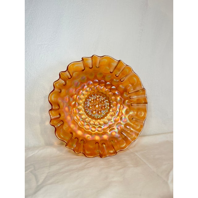 Gorgeous iridescent orange glass, with a kaleidoscopic “Coin Dot” pattern and a darling ruffled edge.