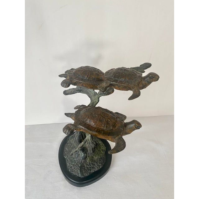 Bring the serene beauty of the ocean into your home with this stunning, heavy cast bronze sea turtle trio sculpture....