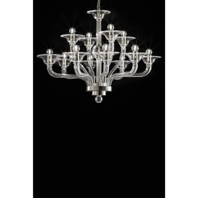 Elegant chandelier in transparent color made in Murano glass and chromed metal frame. For classical and modern interiors,...