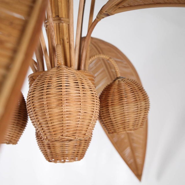 Extra-large rattan chandelier in the shape of a coconut palm. Five lights are integrated into the coconuts, and three...