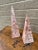 A beautifully proportioned pair of marble obelisks in richly veined shades of pink and cream. The sculptural silhouettes...