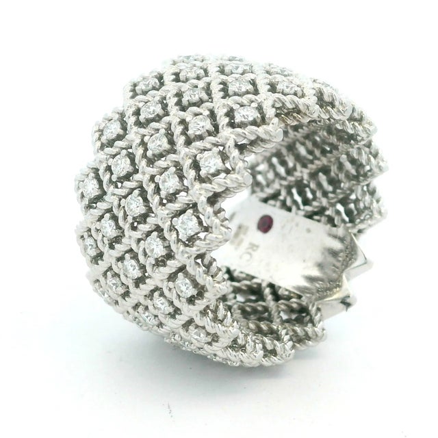 An exceptional wide diamond band by Italian master jeweler Roberto Coin, exquisitely crafted in 18 karat white gold and...