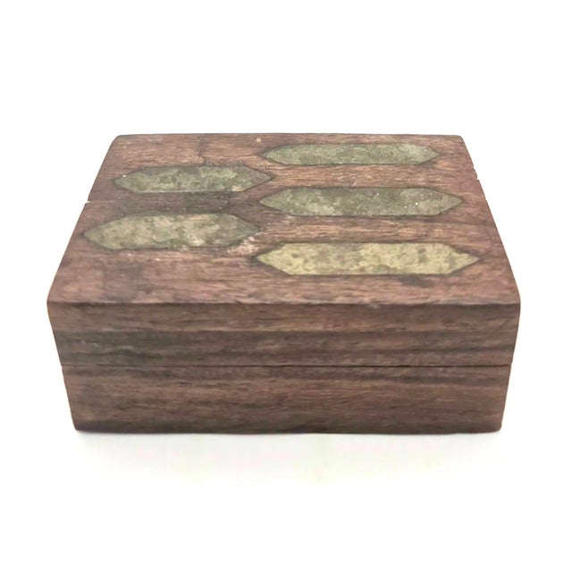 Offered is a small vintage wooden trinket or jewelry box handcrafted with flush-fitted geometric brass inlay patterns on...