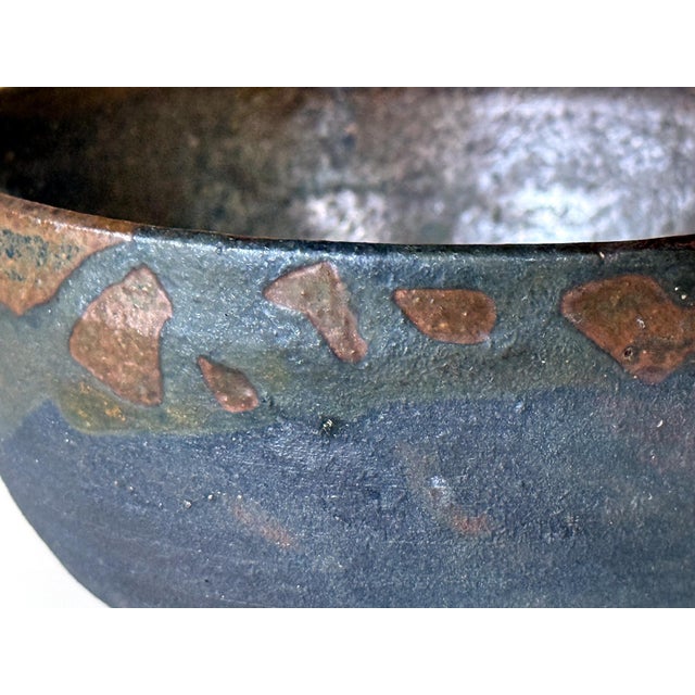 A ceramic bowl by Japanese American artist Toshiko Takaezu (American, 1922 - 2011). The deep form bowl is of the typical...