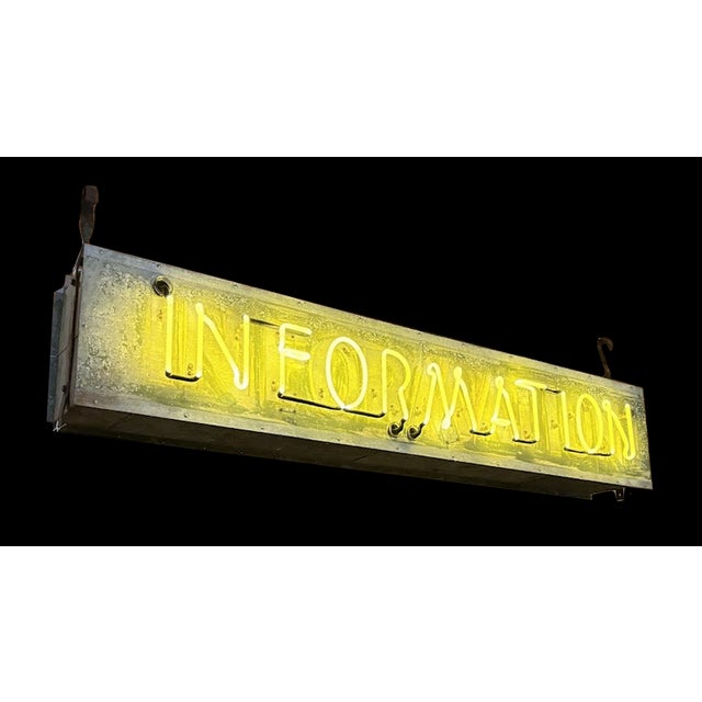 Massive vintage industrial neon yellow sign reading "INFORMATION." Was likely hung at a large public building or...
