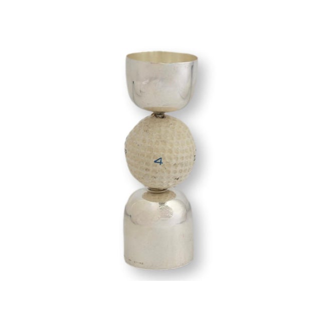 Mid 20th century English double jigger in a sculptural hourglass form, crafted in silverplate and centered with a mounted...