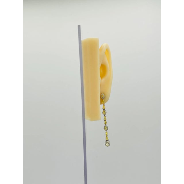 This is part of Chairish’s Fine Jewelry assortment. Gorgeous 1.80 ct. fancy yellow diamond pear shapes (20 stones) with...